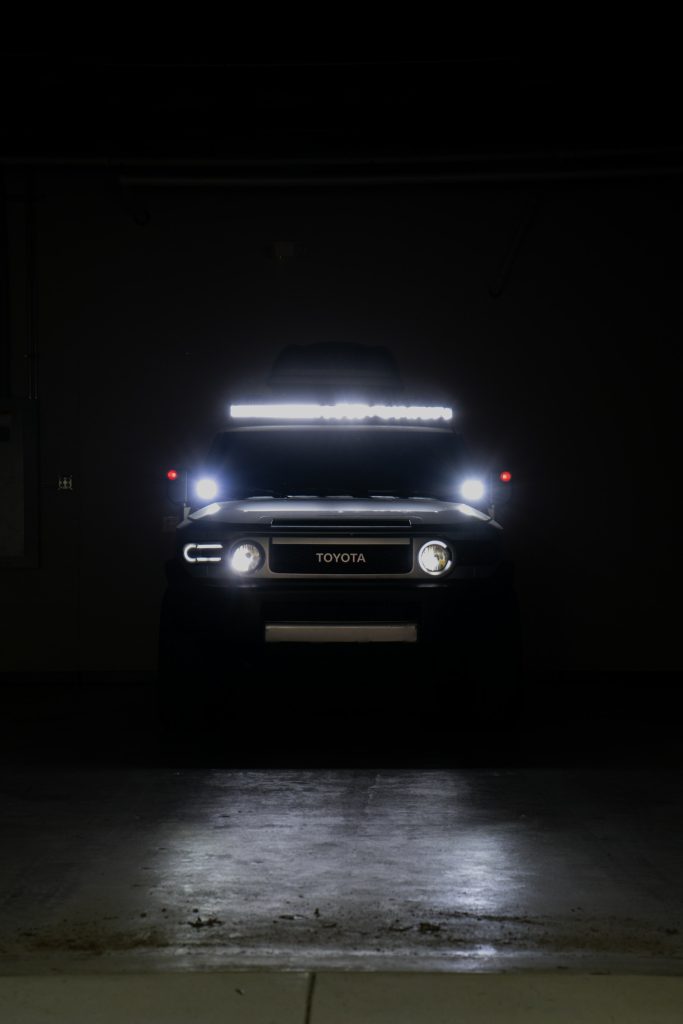 Toyota FJ Cruiser with a roof LED light bar and spotlights at night