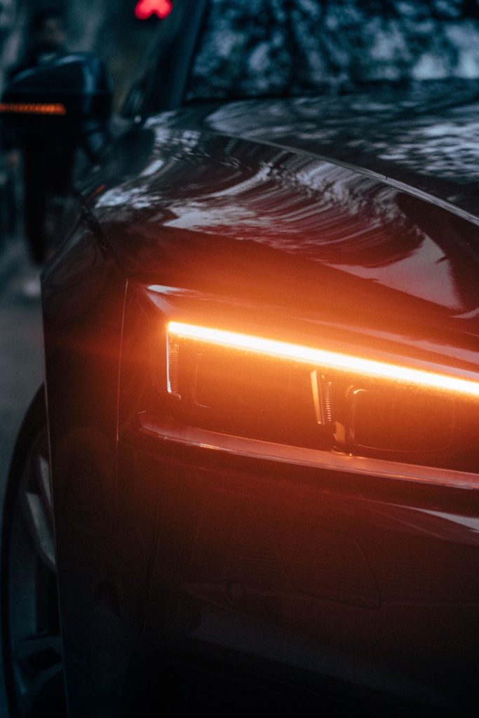 Amber LED daytime running light glowing on a headlamp at night